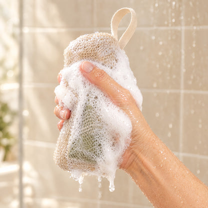 Hand squeezing the Foaming Bar Pouch full of creamy lather in the shower